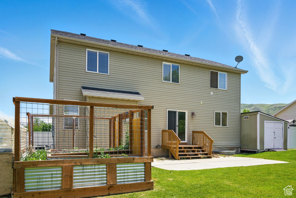 Back of house featuring a vegetable garden and a patio