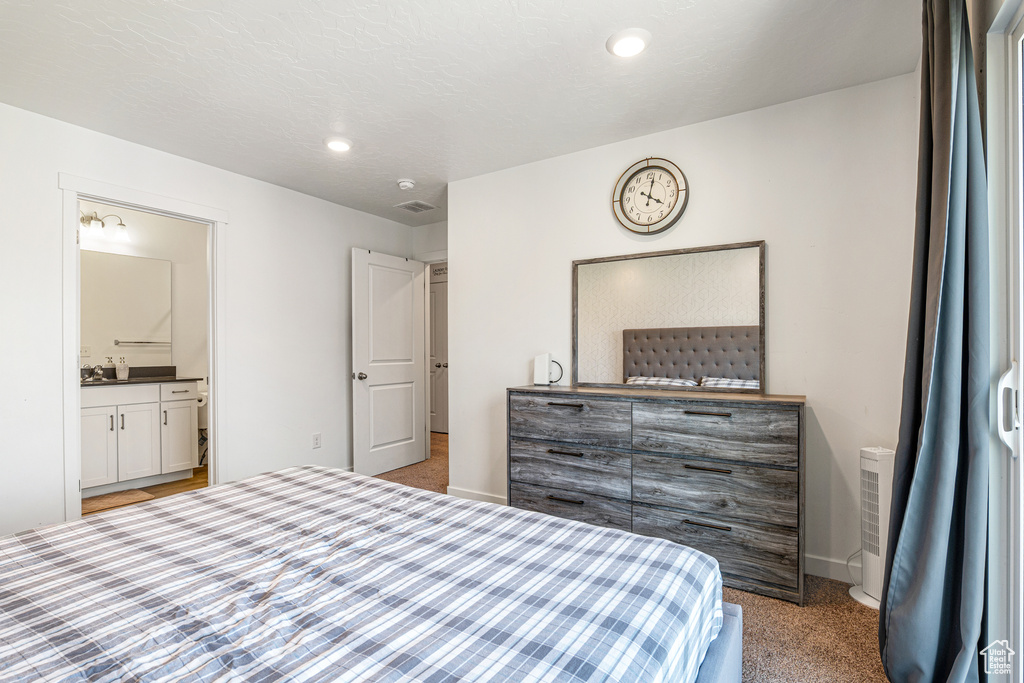 Bedroom featuring carpet flooring, ensuite bath, baseboards, and recessed lighting