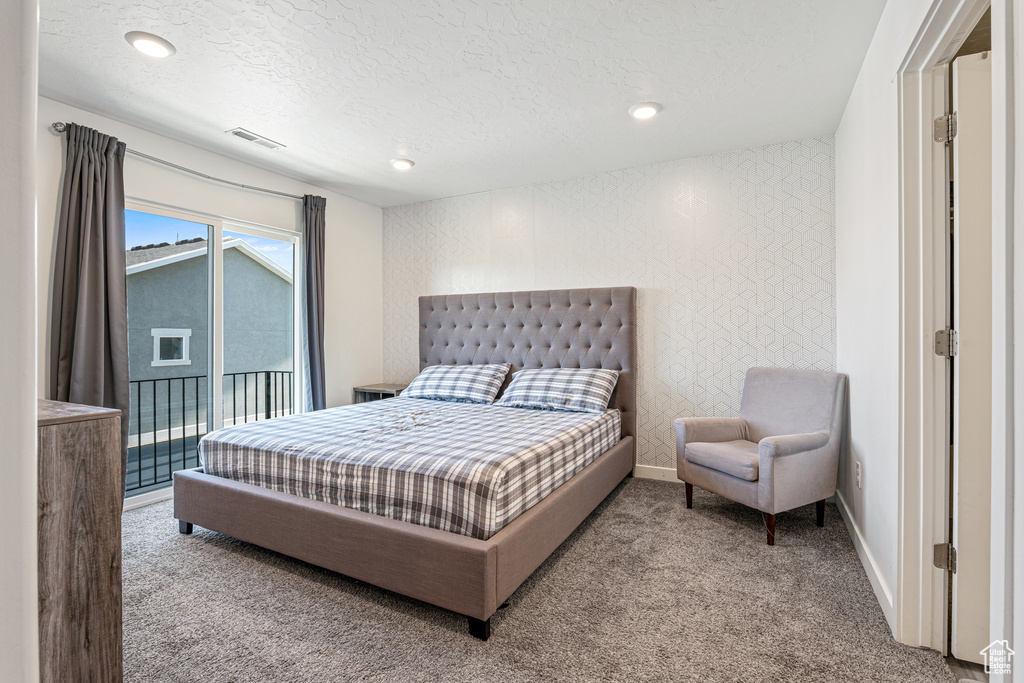 Carpeted bedroom featuring a textured ceiling, access to outside, baseboards, and recessed lighting