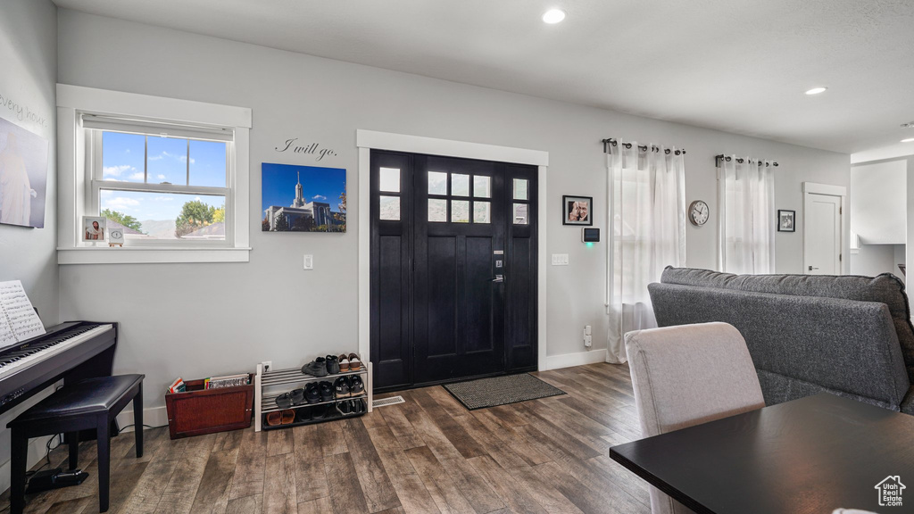 Entrance foyer featuring dark wood-style flooring, recessed lighting, and baseboards