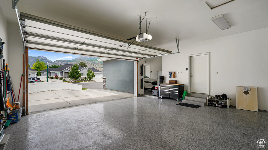 Garage with a garage door opener and a mountain view