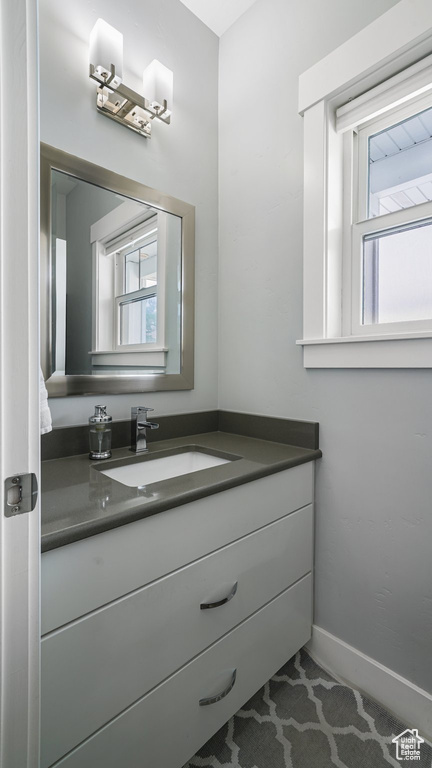 Bathroom with vanity and baseboards