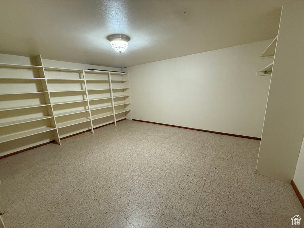 Walk in closet with tile patterned floors