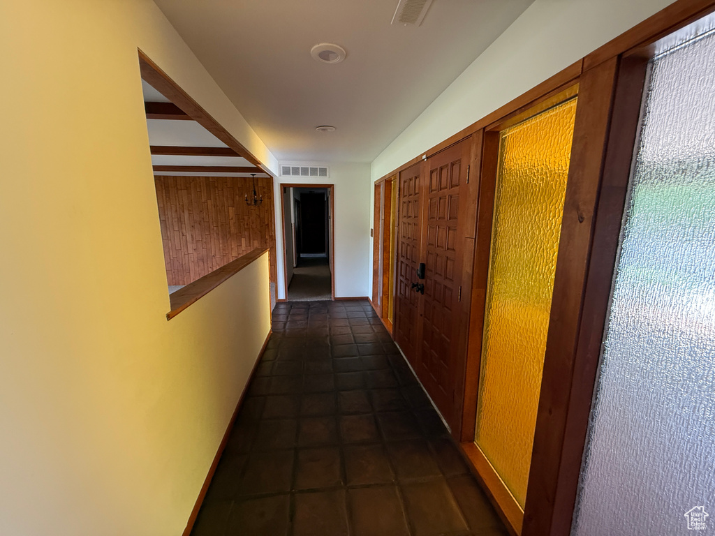 Corridor featuring dark tile patterned flooring