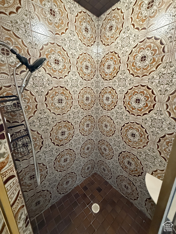Full bath with tile patterned flooring and a tile shower