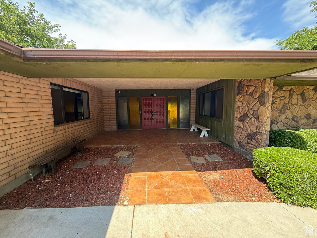 Property entrance featuring brick siding