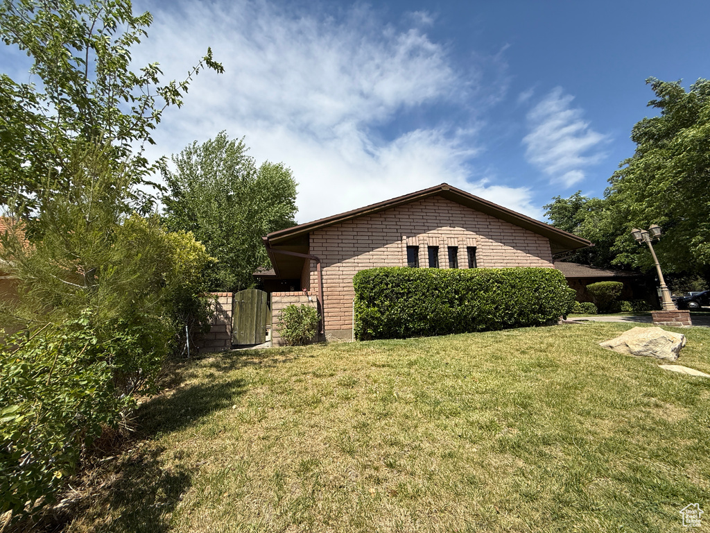 View of home\'s exterior with a yard