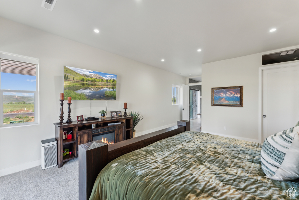 Carpeted bedroom with recessed lighting and baseboards