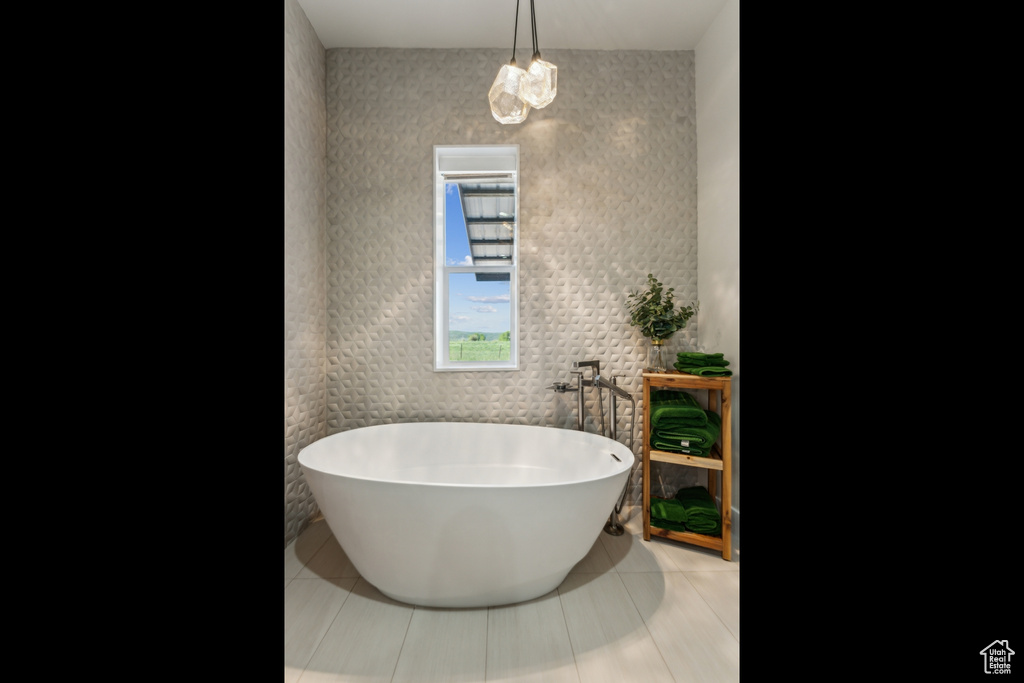 Full bath featuring tile patterned floors and a soaking tub