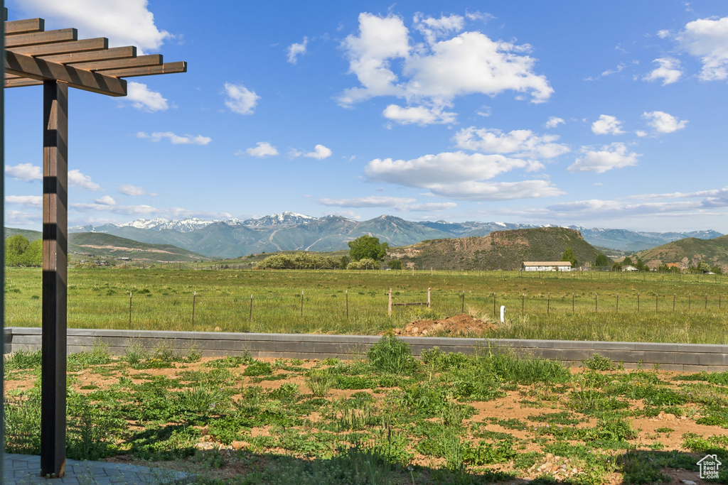 View of mountain backdrop with rural landscape and a pastoral area