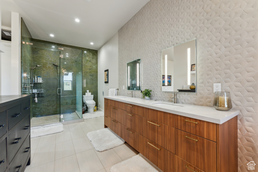 Full bath featuring double vanity, tile patterned flooring, a stall shower, toilet, and recessed lighting