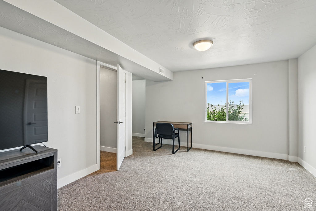 Home office with carpet flooring and baseboards