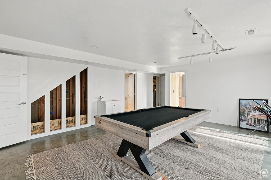 Playroom with billiards and concrete floors