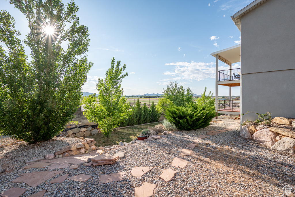 View of yard featuring a balcony