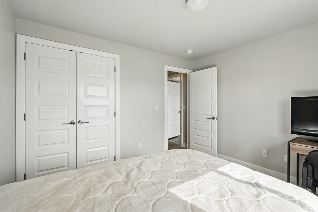 Bedroom featuring a closet and baseboards