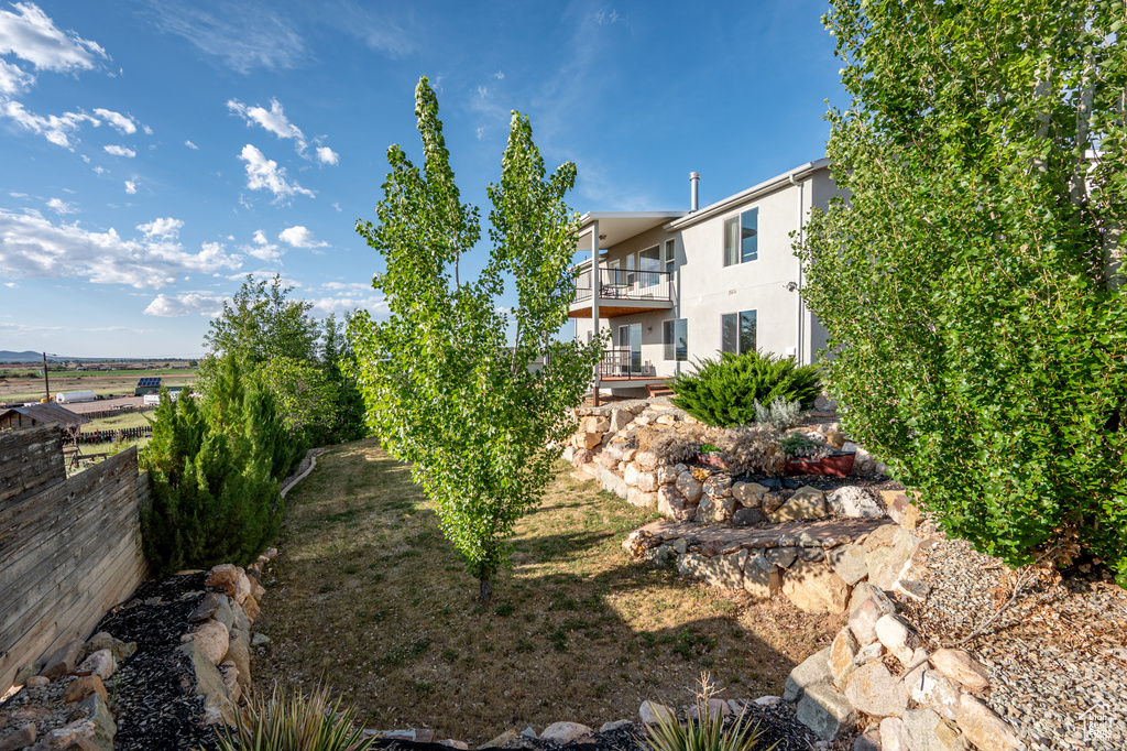 View of yard featuring a balcony