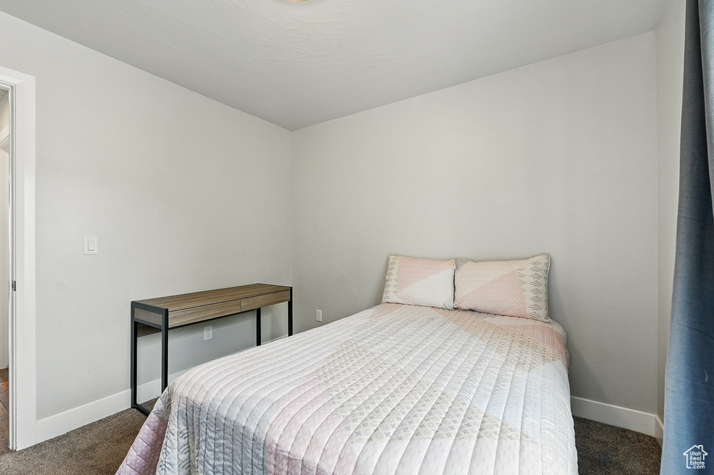 Carpeted bedroom with baseboards