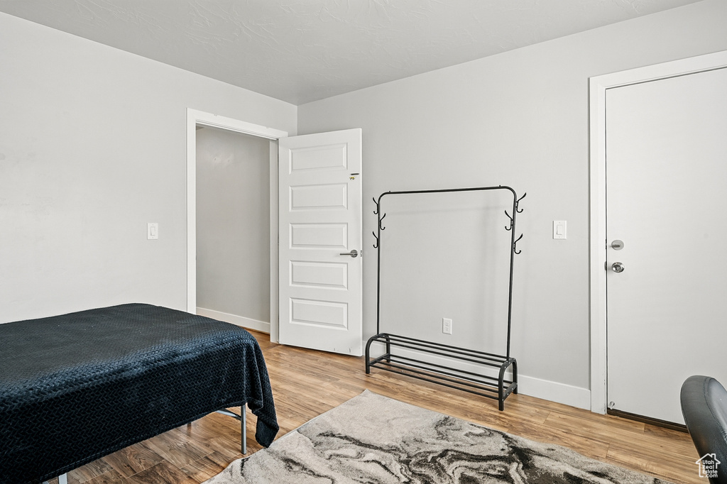 Bedroom featuring light wood-style flooring and baseboards