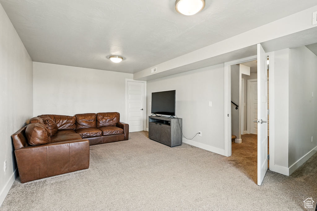 Carpeted living room with baseboards