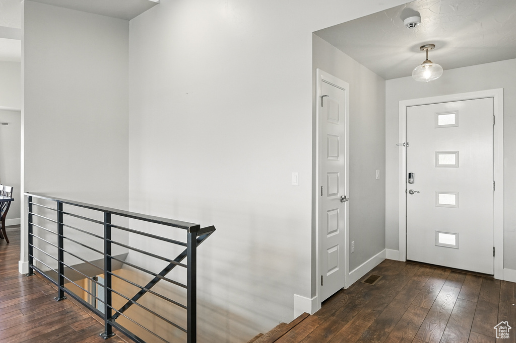 Foyer with hardwood / wood-style floors and baseboards
