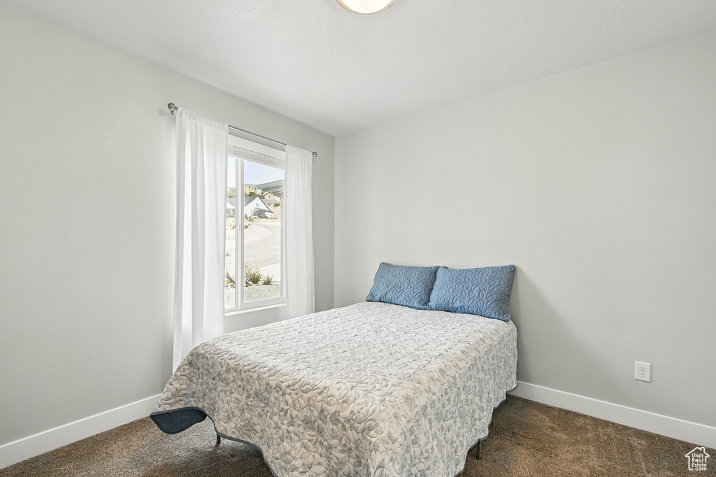 Carpeted bedroom featuring baseboards