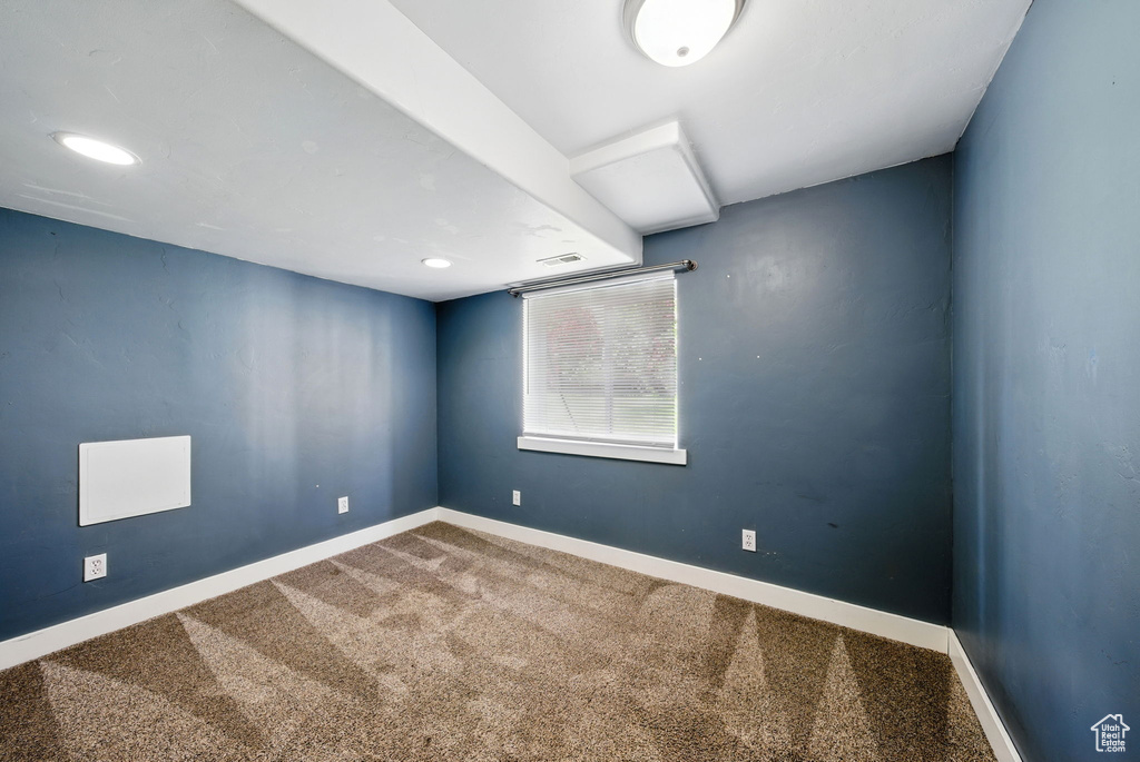 Unfurnished room featuring carpet and baseboards