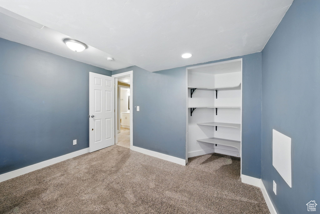 Unfurnished bedroom with carpet and baseboards