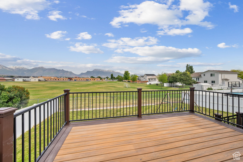 Deck featuring a mountain view, a residential view, and a lawn