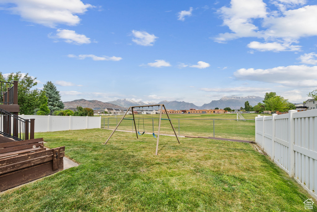 View of yard with a playground and a mountain view
