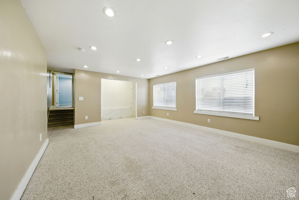 Unfurnished room with recessed lighting, baseboards, carpet flooring, and a smoke detector