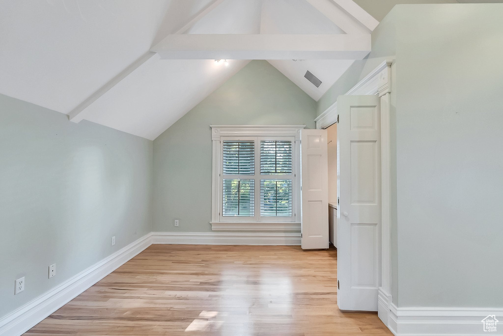 Additional living space with light wood finished floors and baseboards