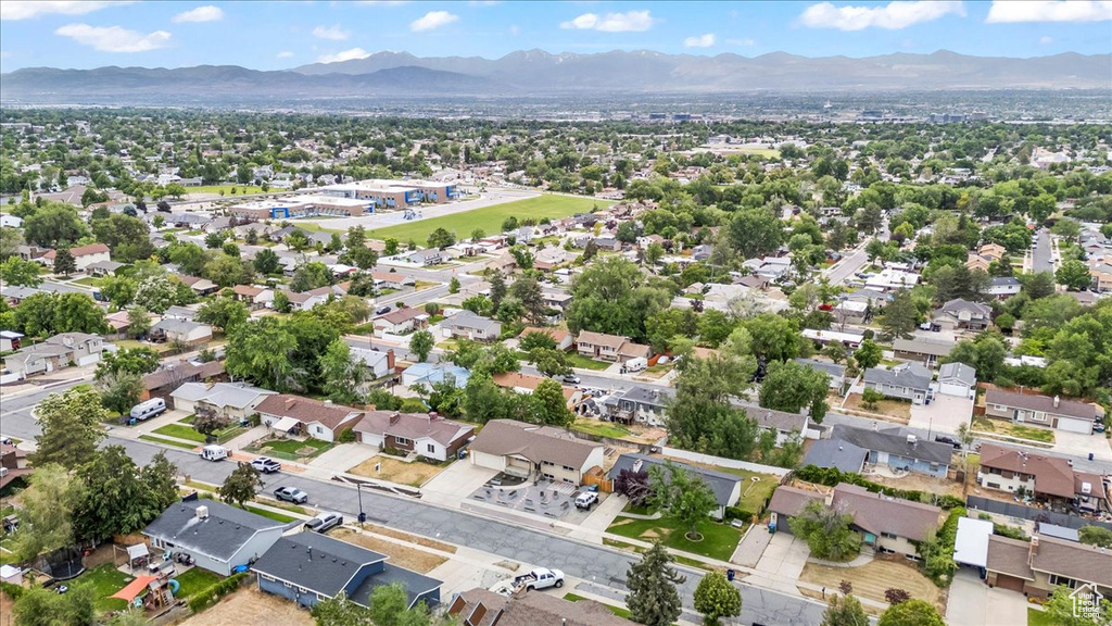Aerial view of property's location featuring a mountainous background and nearby suburban area