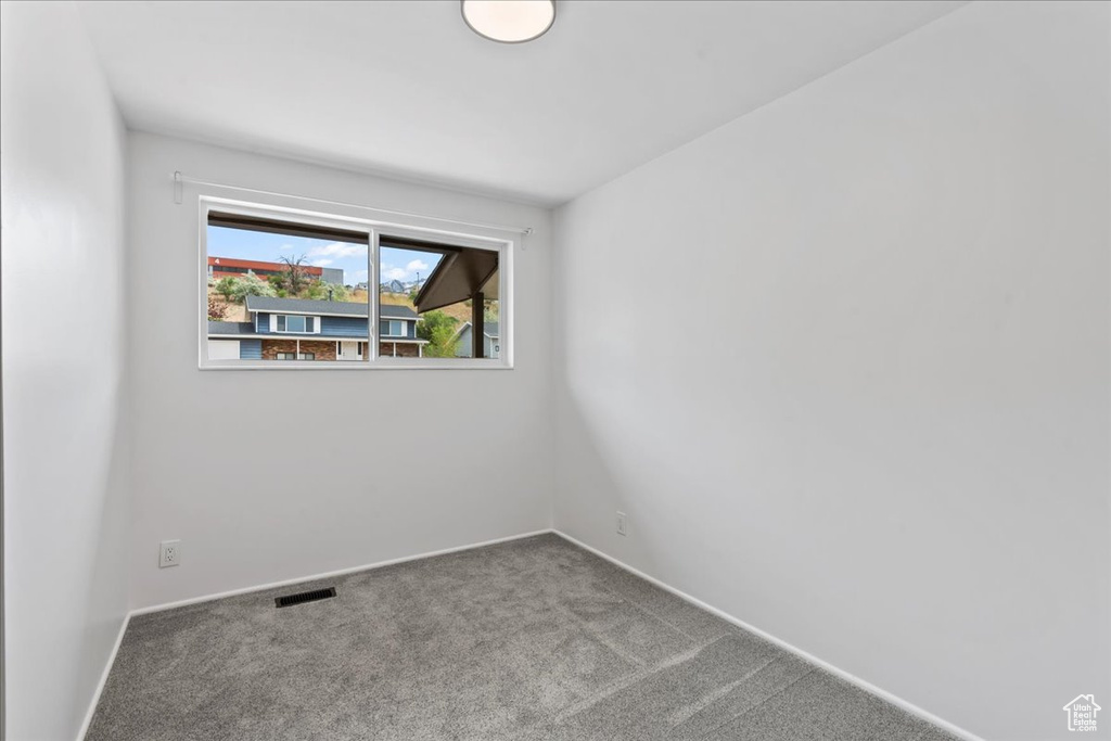 Unfurnished room with carpet flooring and baseboards