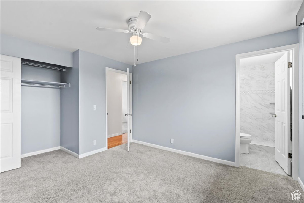 Unfurnished bedroom featuring carpet, a closet, baseboards, and connected bathroom