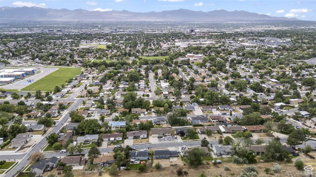Aerial view of property and surrounding area with mountains