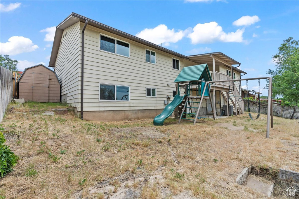 Back of house featuring a playground