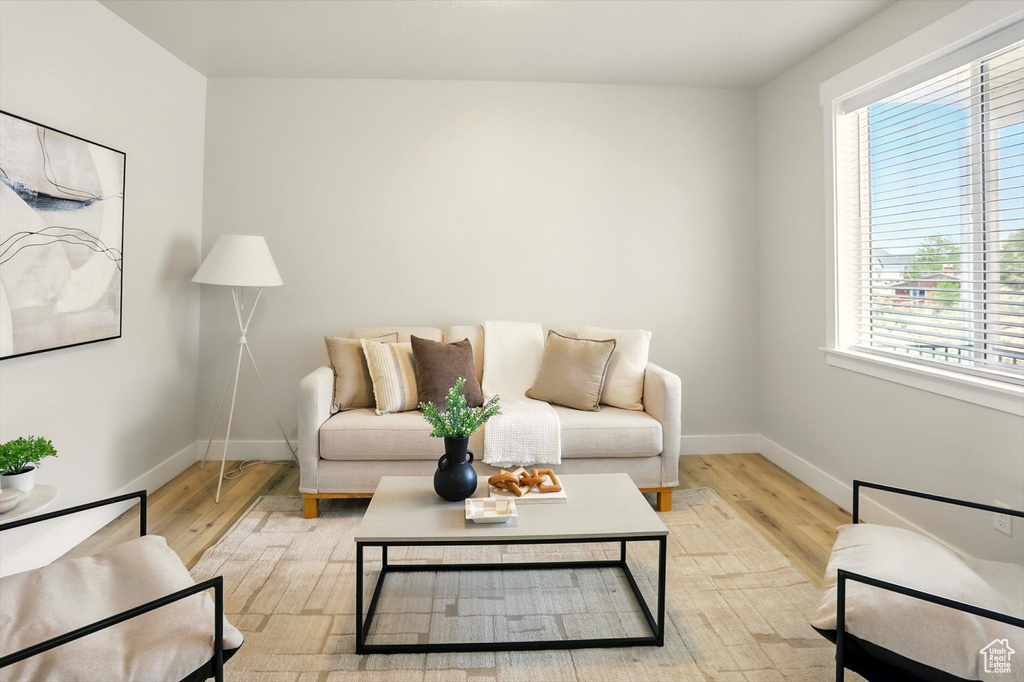 Living area featuring baseboards and light wood-type flooring