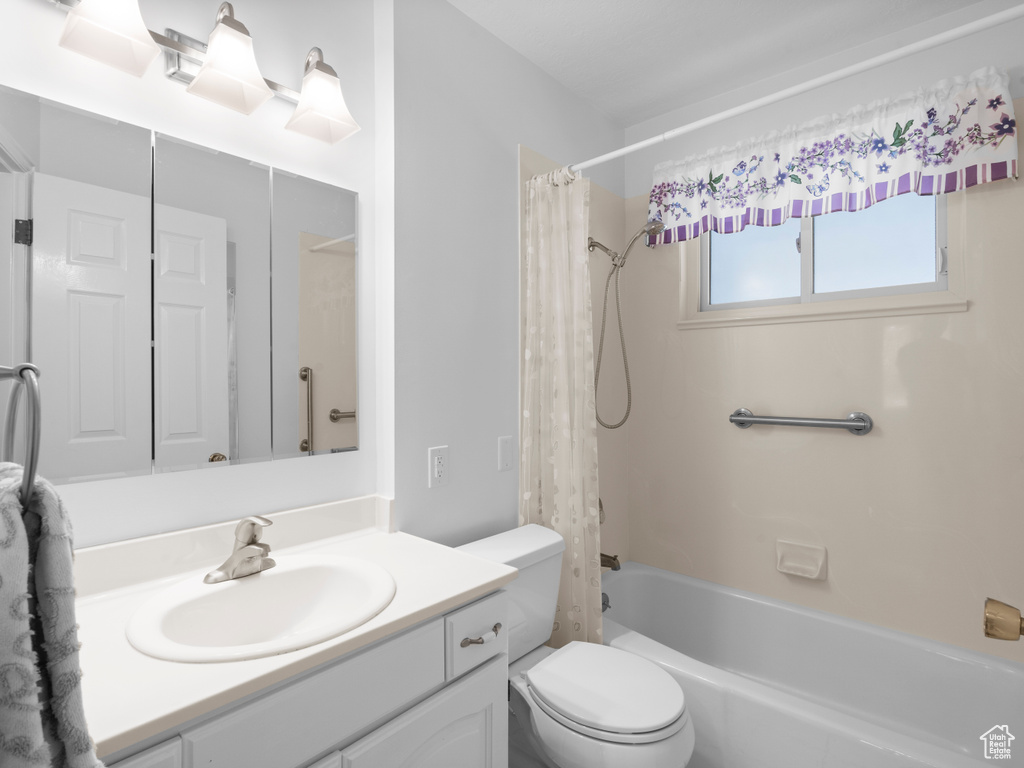 Full bathroom with vanity, toilet, and shower / bathtub combination with curtain