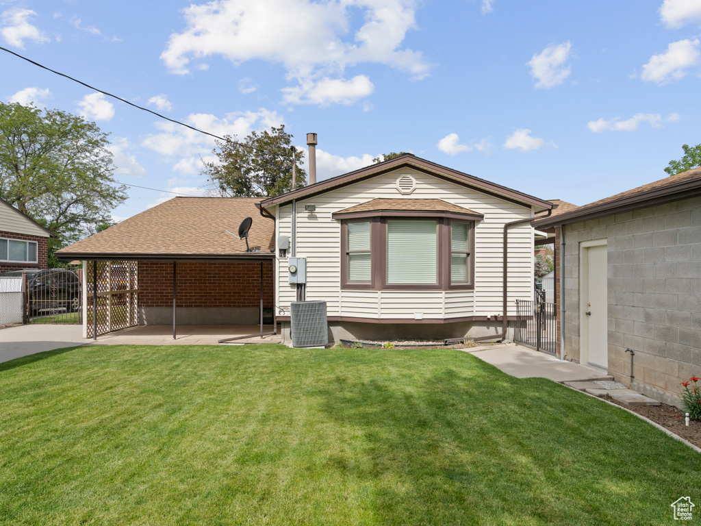 Rear view of property with a gate and a patio