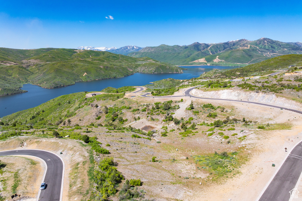 Aerial view of property's location with a water and mountain view