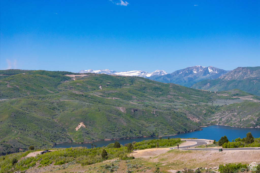 View of mountain backdrop featuring a nearby body of water