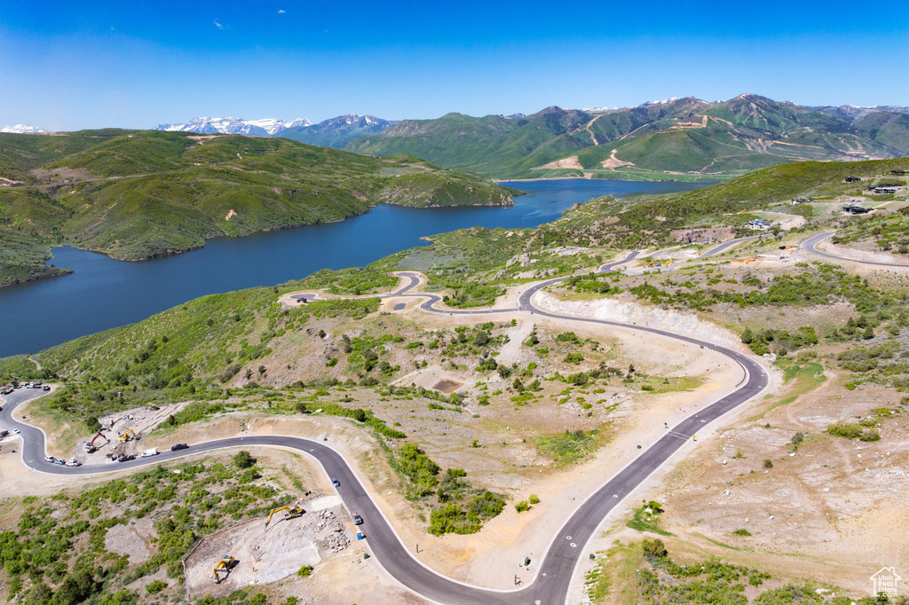 Aerial view of property's location with a water and mountain view