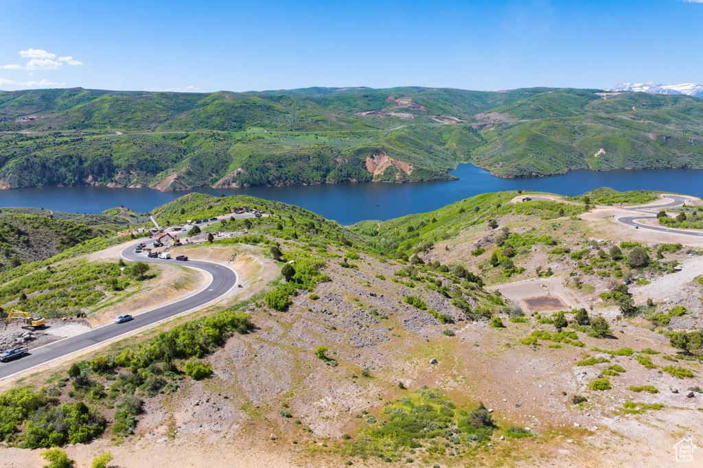 Aerial view of property's location with a water and mountain view