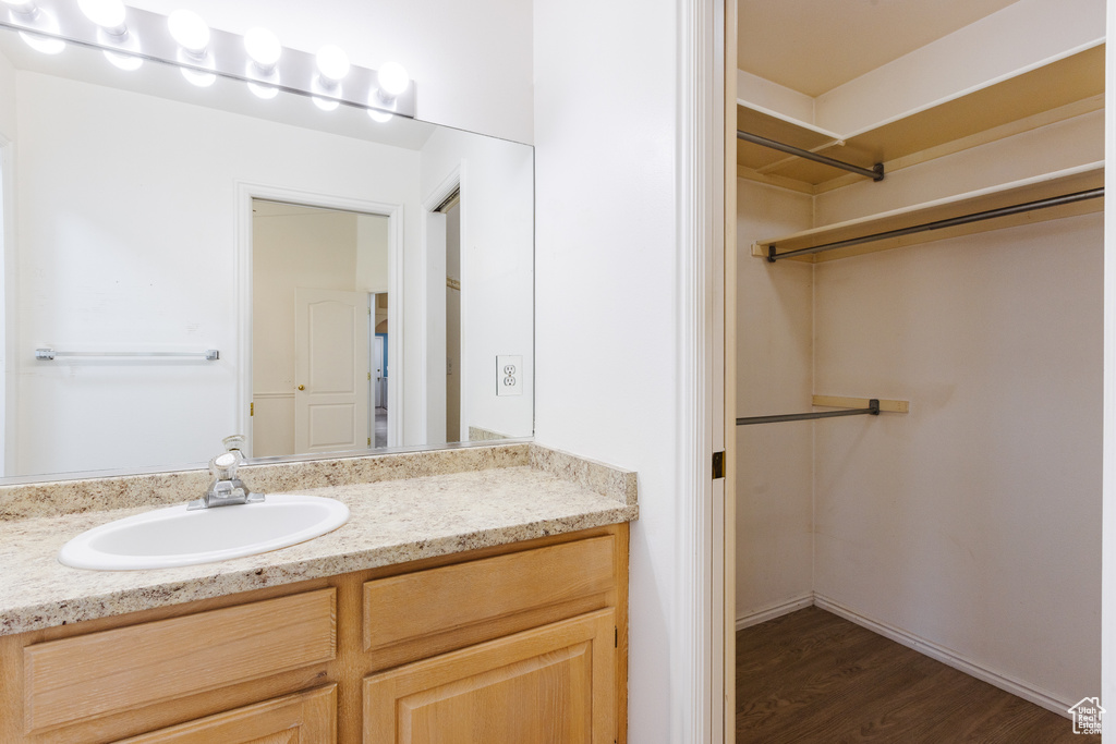 Bathroom featuring vanity and wood finished floors