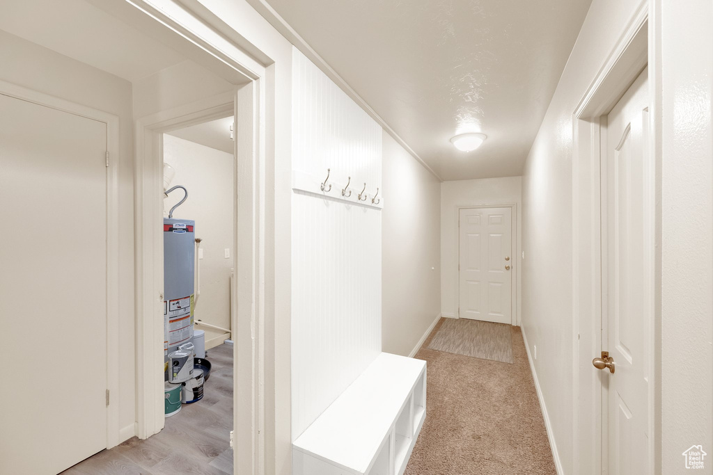Hallway featuring gas water heater