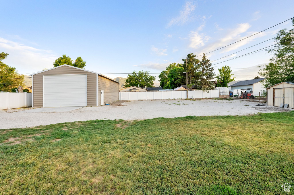View of yard featuring an outbuilding and a garage