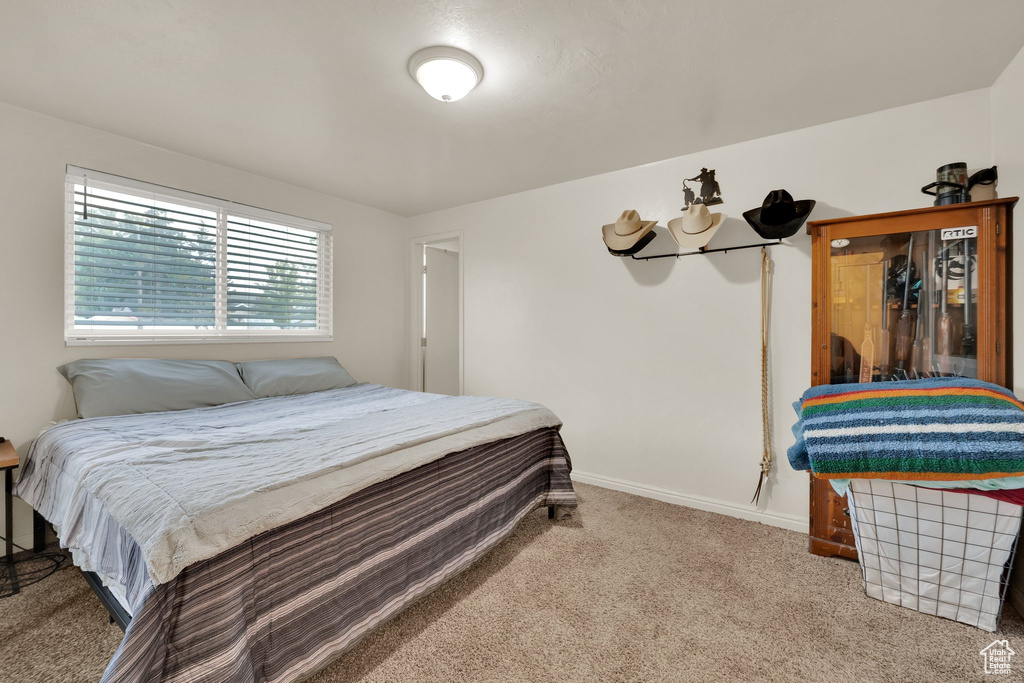 Bedroom featuring carpet floors and baseboards