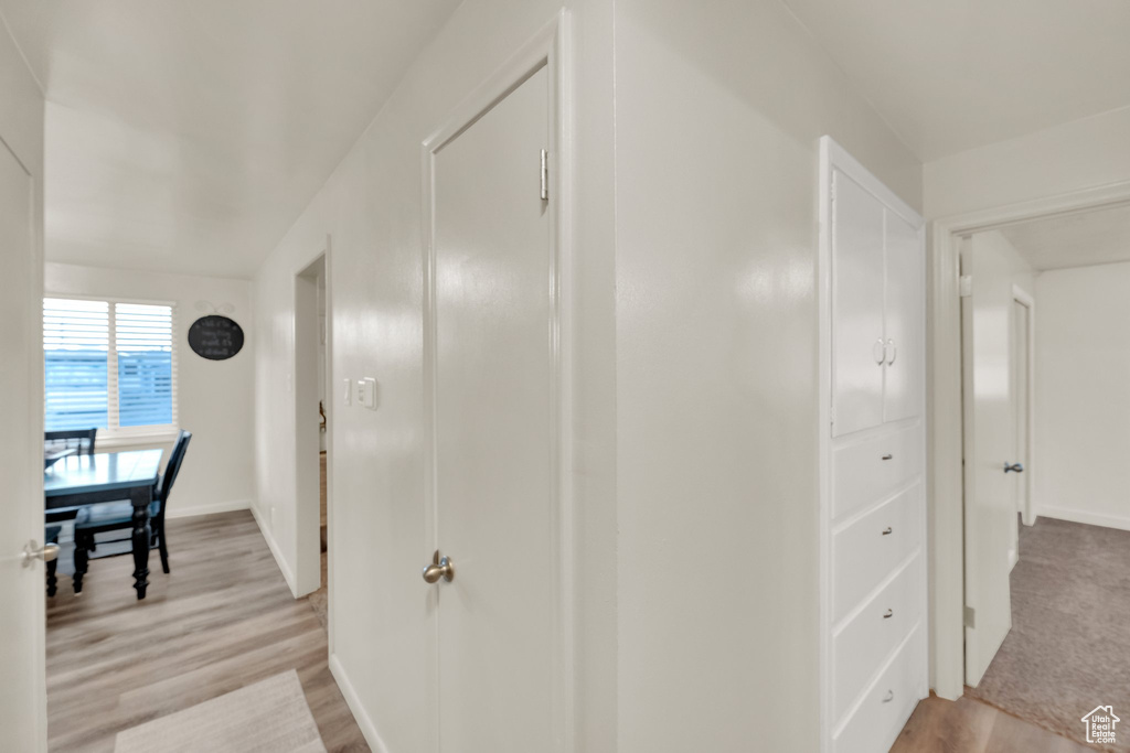 Hallway featuring light wood-style floors and baseboards