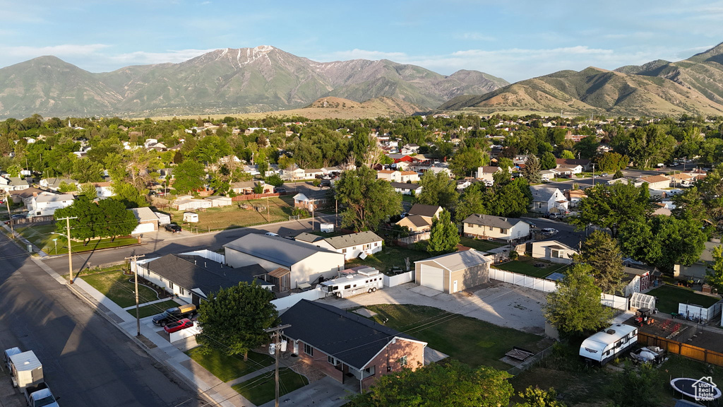 Aerial view of property's location featuring nearby suburban area and a mountainous background