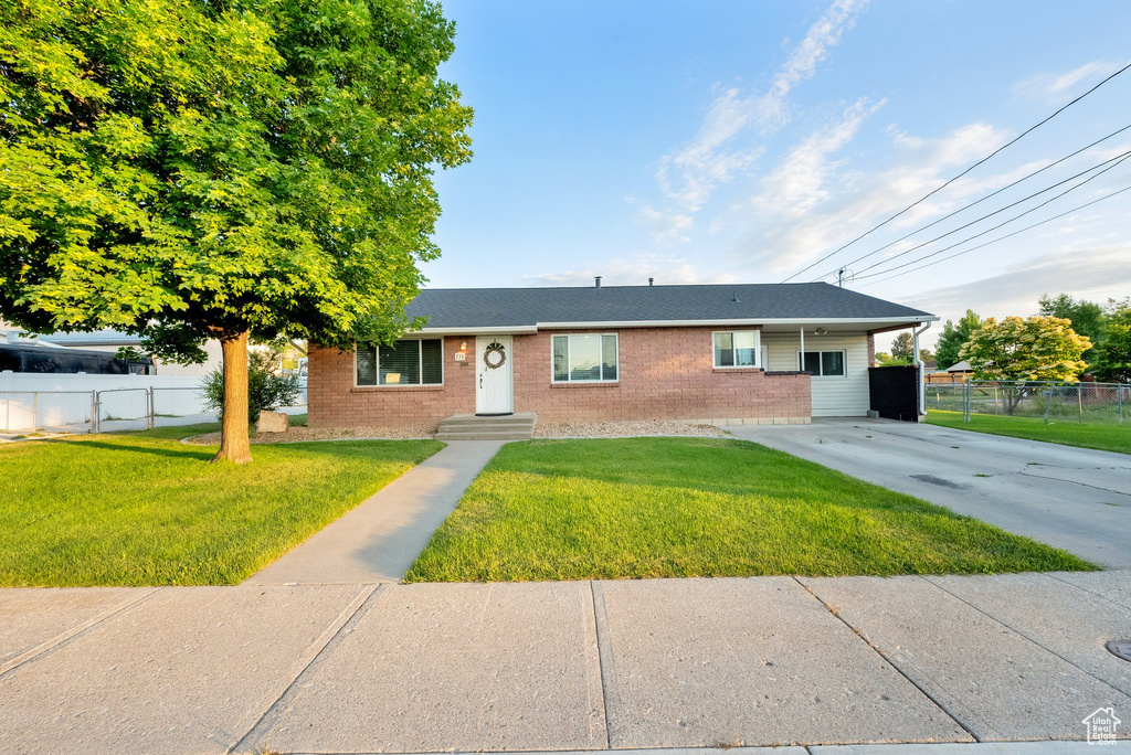 Single story home featuring brick siding and driveway